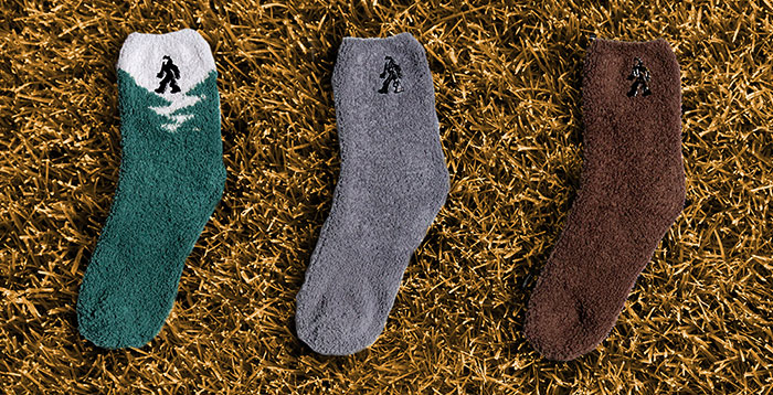 Fuzzy man socks on prickly grass